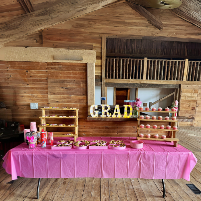 Decorated table with 'GRAD' letters in a rustic wooden building.