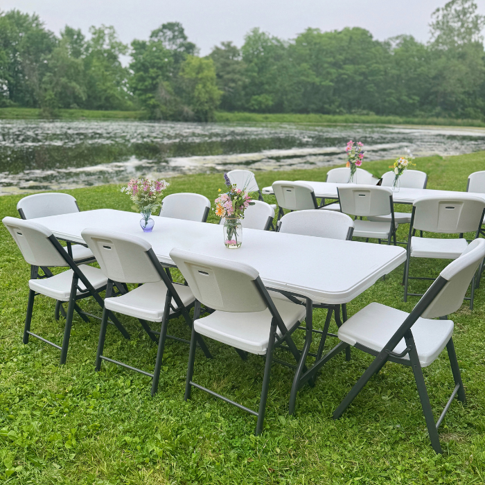 white 8 foot table surrounded by chairs