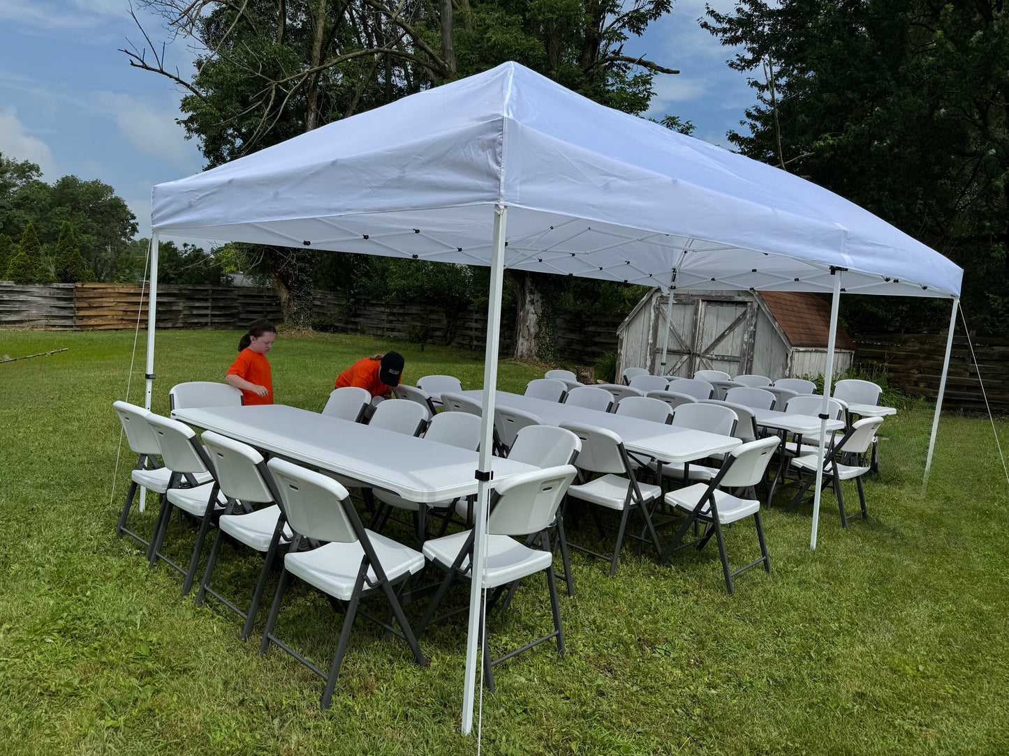 white canopy tent with white tables and chairs