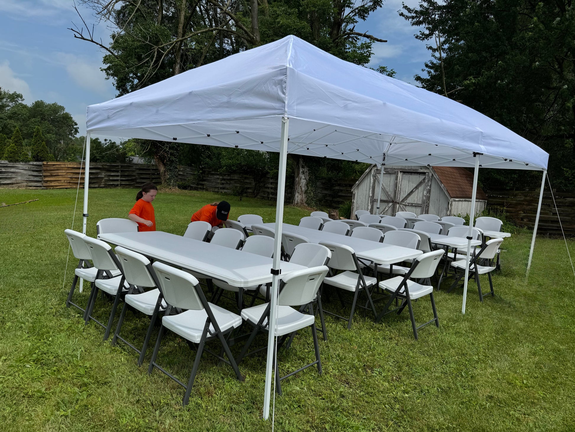 white canopy tent with white tables and chairs