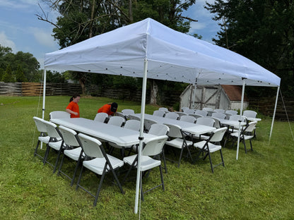 white canopy tent with white tables and chairs
