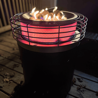 Portable propane fire pit with flames on a wooden deck